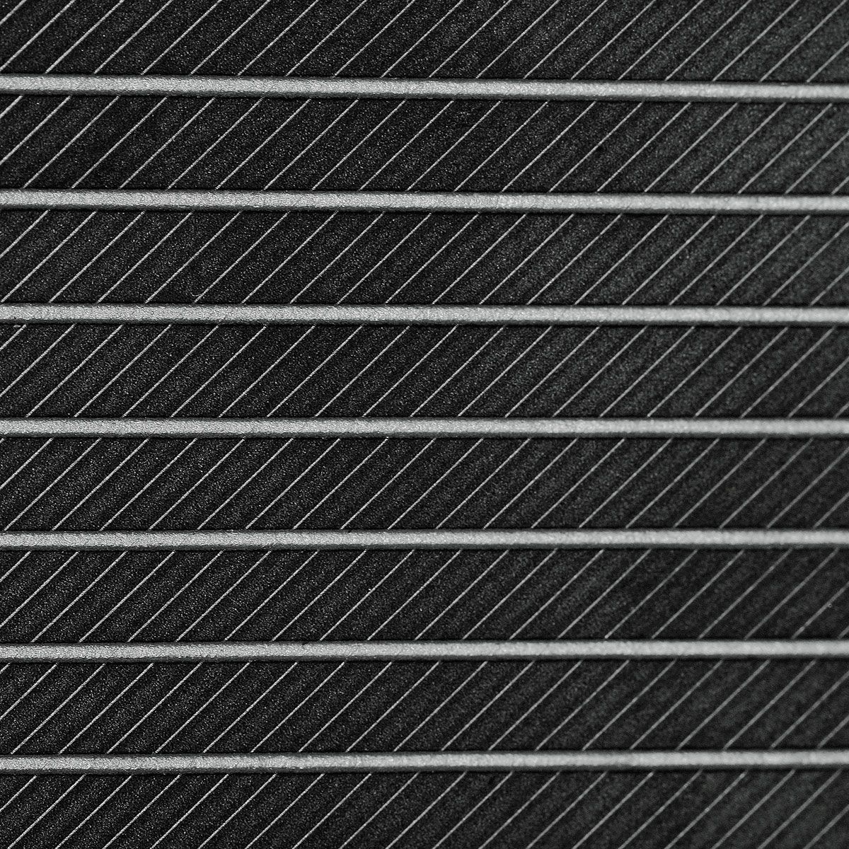 Close-up macro of the Juggernaut Max full face wedge face, showing the milled groove pattern running the full width of the striking surface.